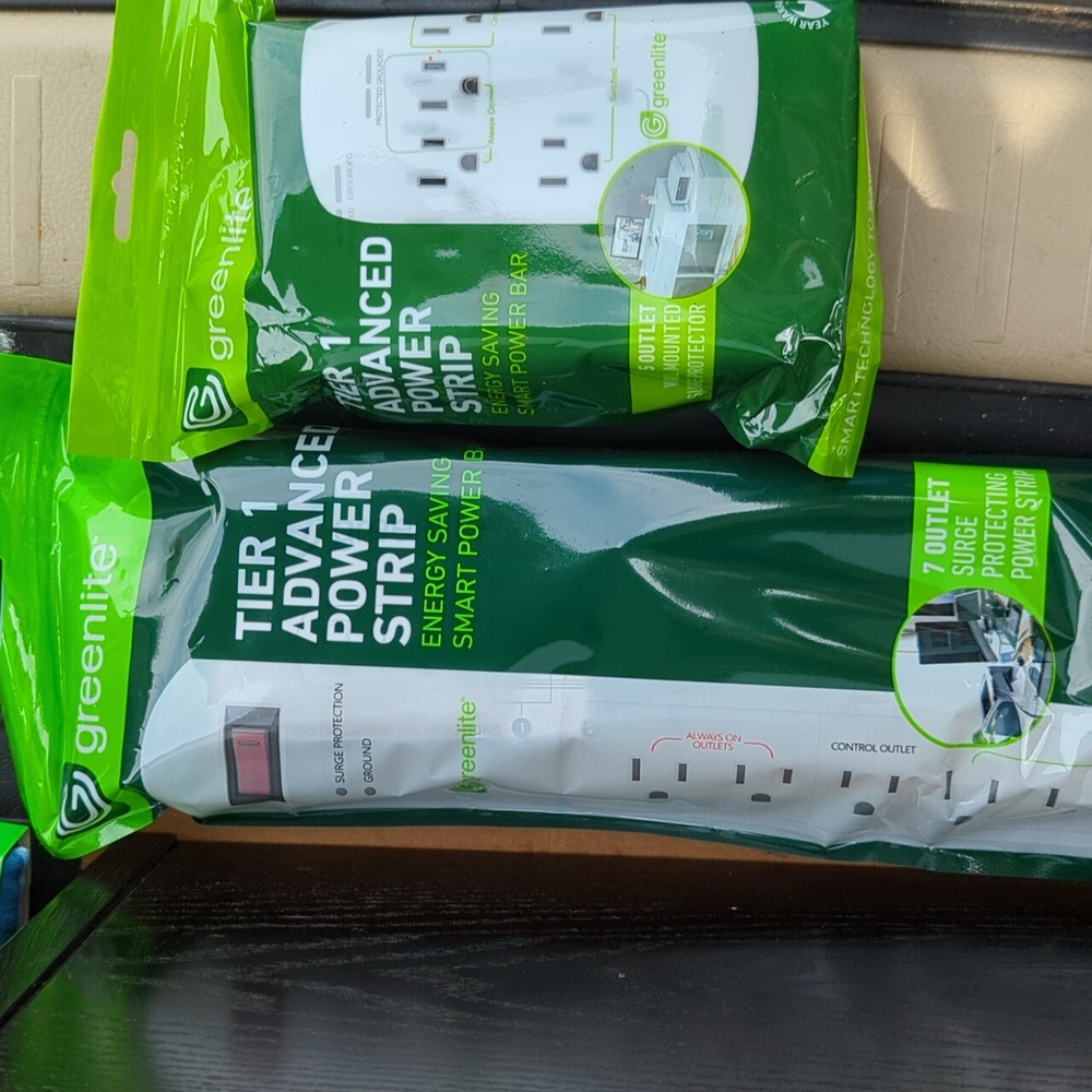 Two Surge protectors by green light